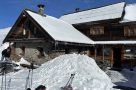 Clearing snow at a mountain hut in the valley