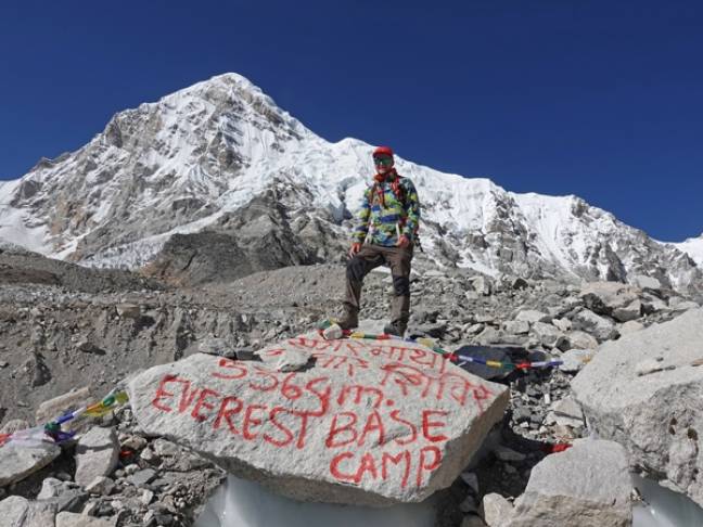 Guide to trekking to everest base camp standing at base camp
